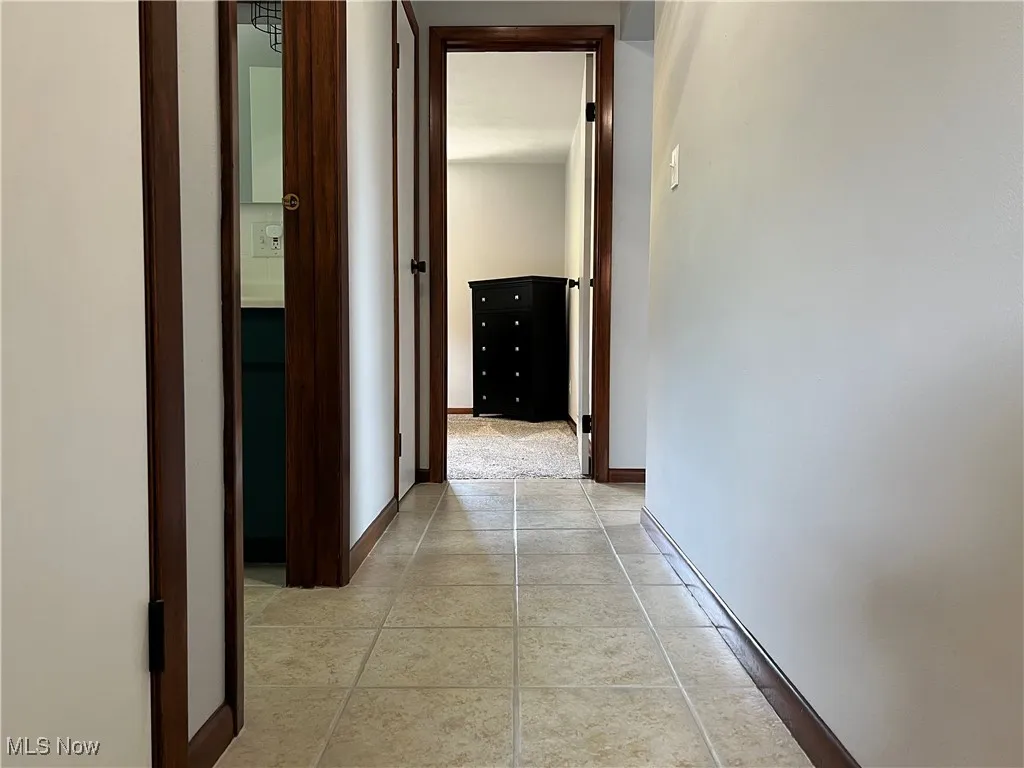 Hallway featuring baseboards