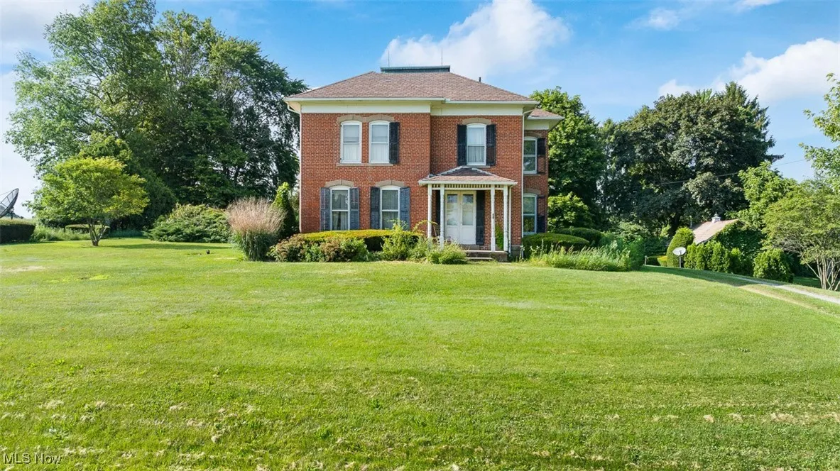 View of front of property with a front lawn and brick siding