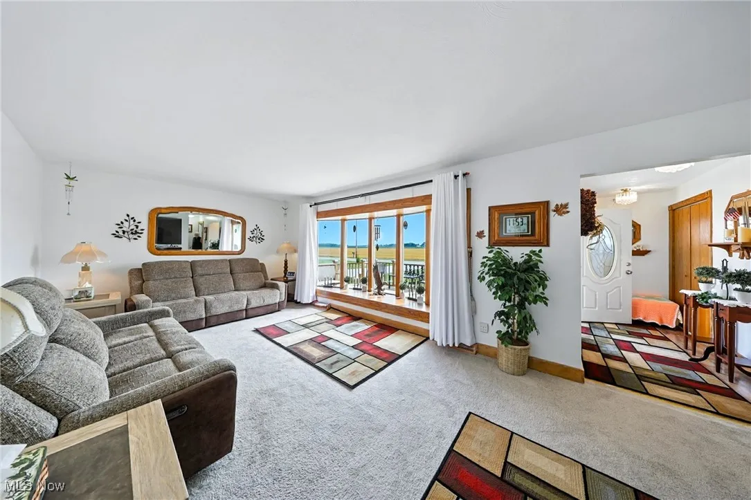 Carpeted living room featuring baseboards