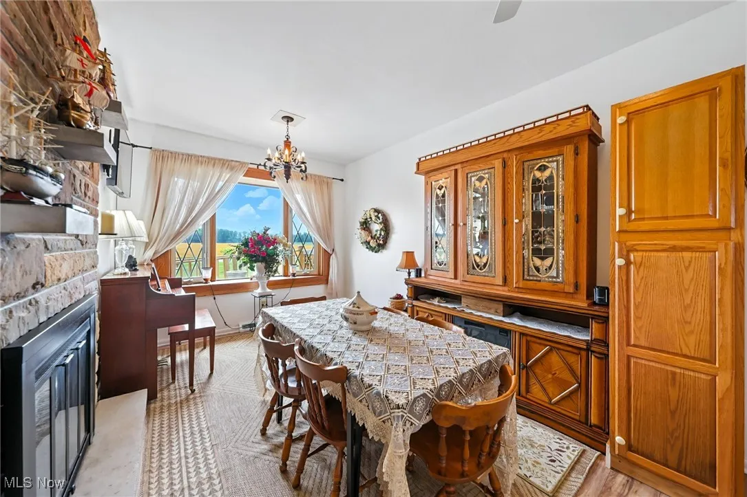 Dining area featuring a chandelier and a fireplace