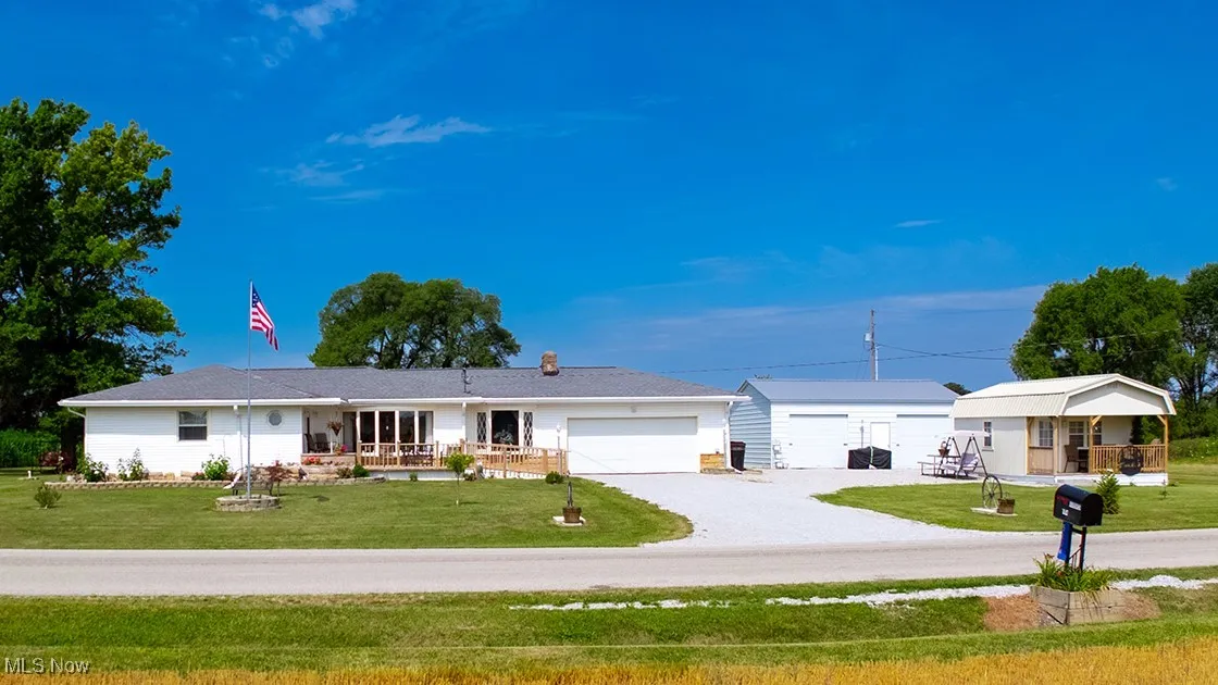 Single story home featuring covered porch and a front yard