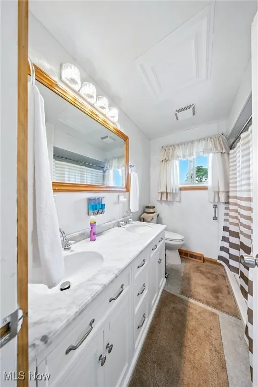 Full bath featuring double vanity and a shower with curtain