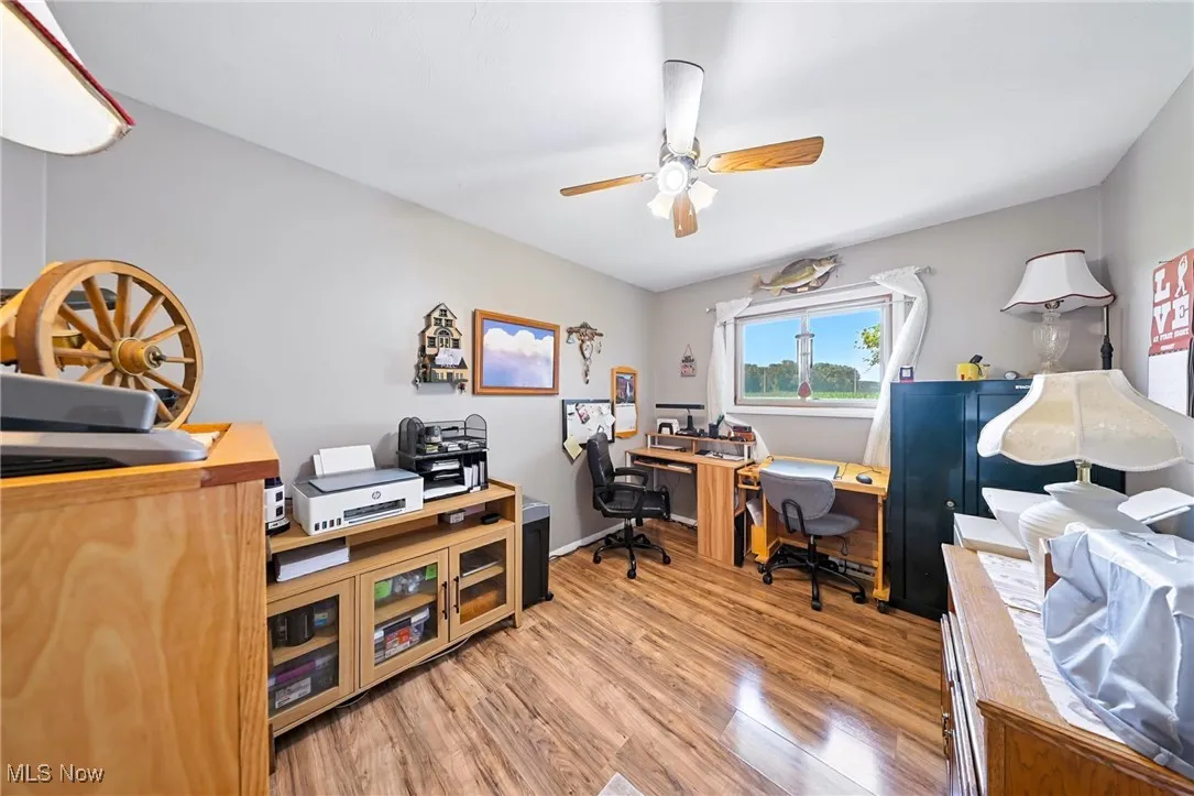 Home office with ceiling fan and wood finished floors