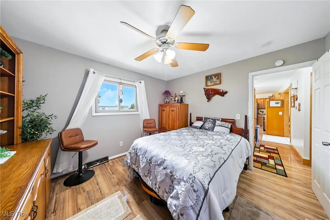 Bedroom with light wood finished floors and a ceiling fan