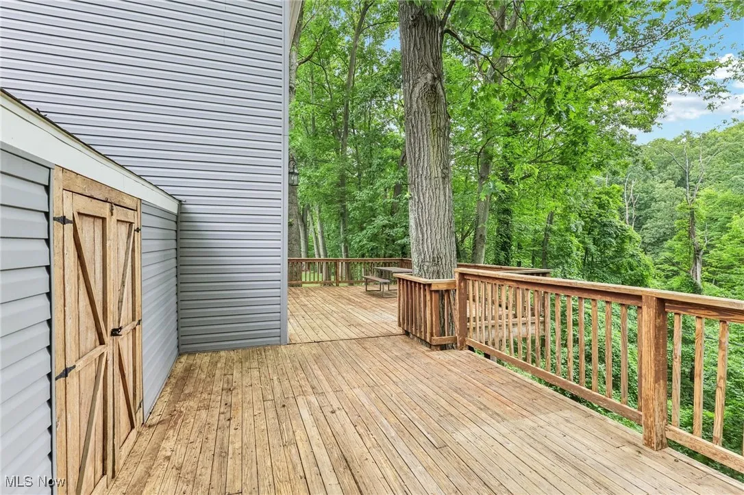 Wooden terrace featuring a forest view