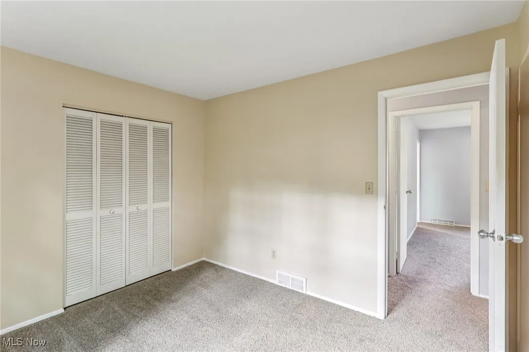 Unfurnished bedroom with carpet flooring and a closet