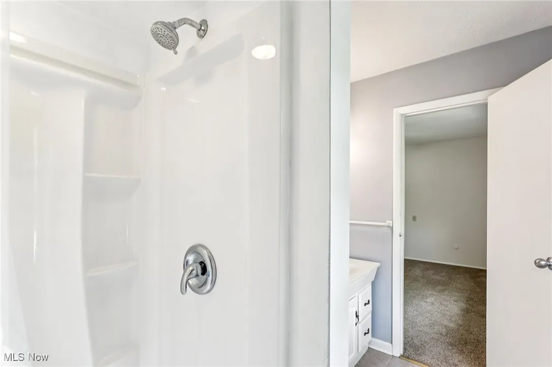 Full bath with a shower and vanity