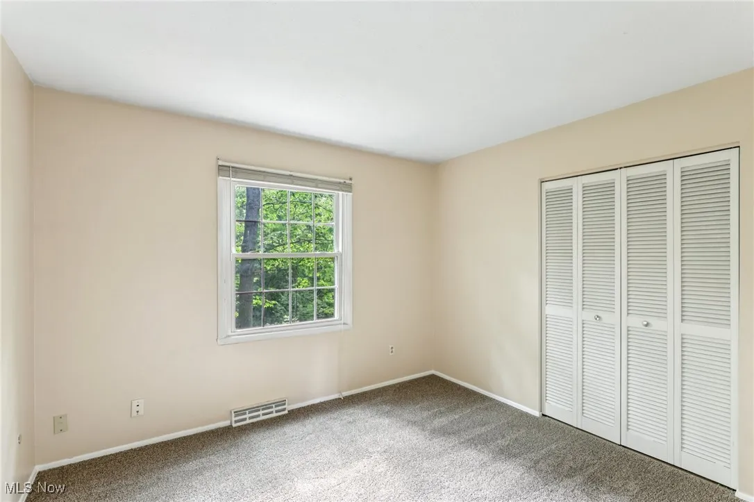 Unfurnished bedroom with carpet floors and a closet