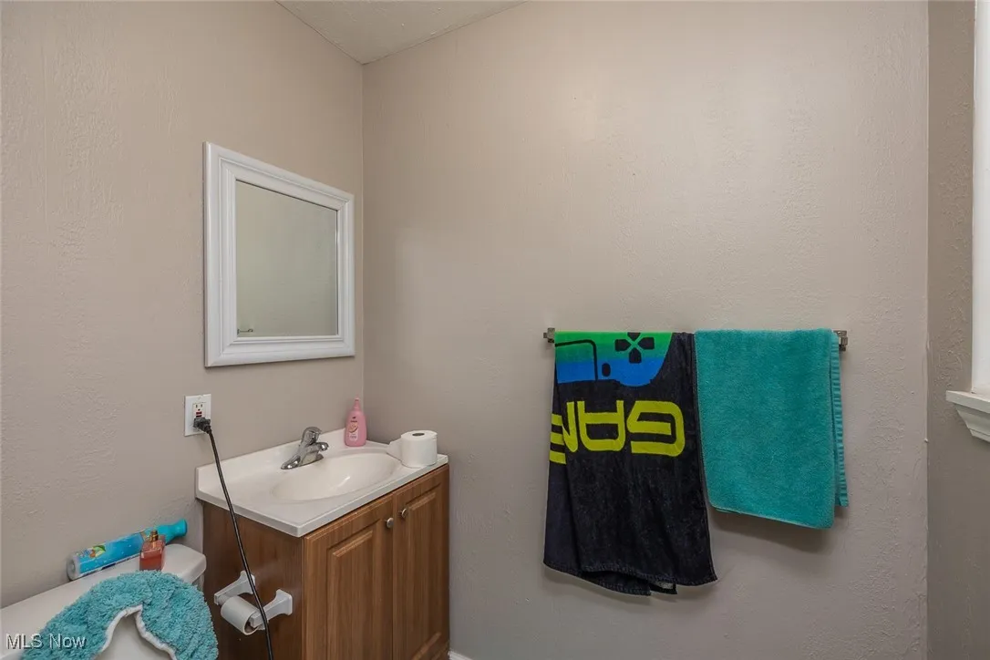 Half bath featuring vanity and toilet