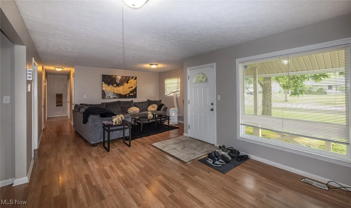 Living room featuring a textured ceiling and wood finished floors
