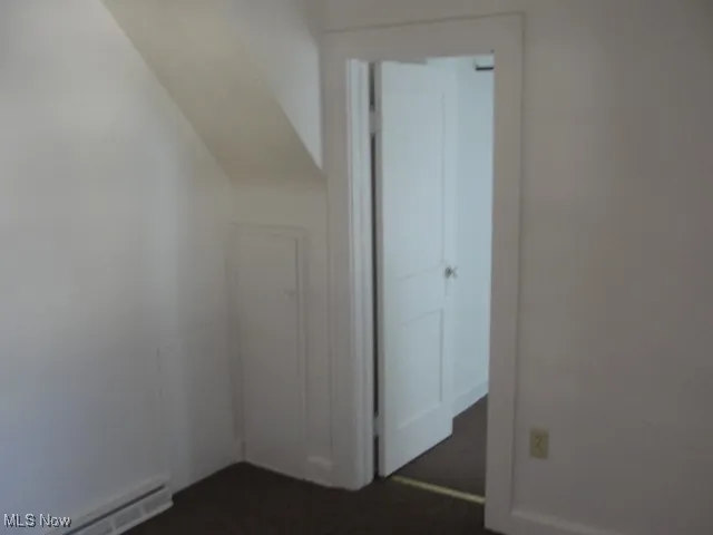 Bonus room featuring baseboard heating