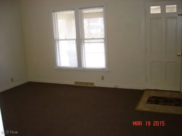 Carpeted entryway featuring baseboards