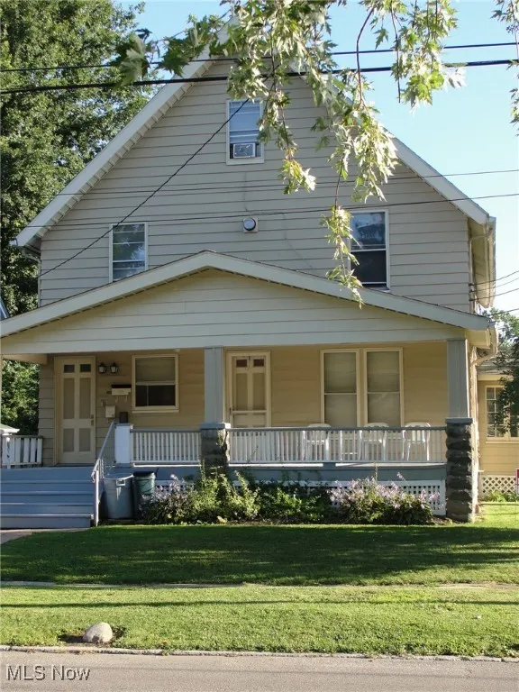 View of front of house featuring a porch and a front lawn