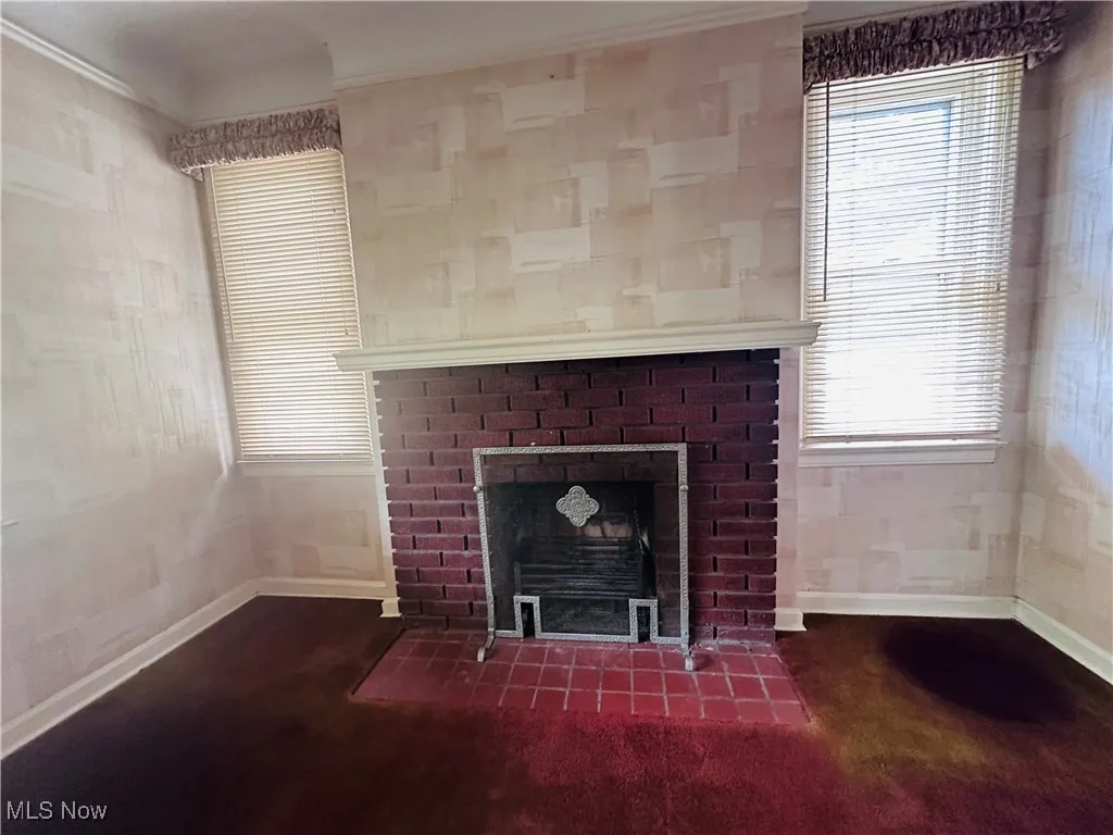 Detailed view of a brick fireplace and ornamental molding