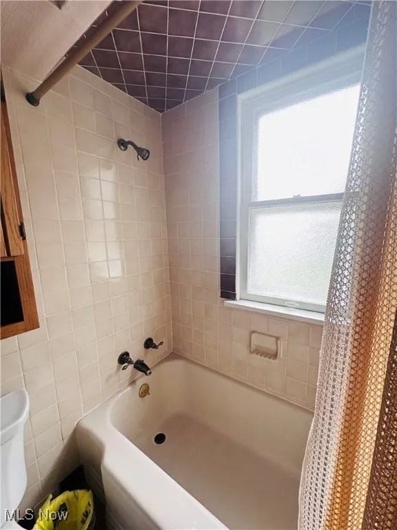 Bathroom with shower / bath combo and toilet