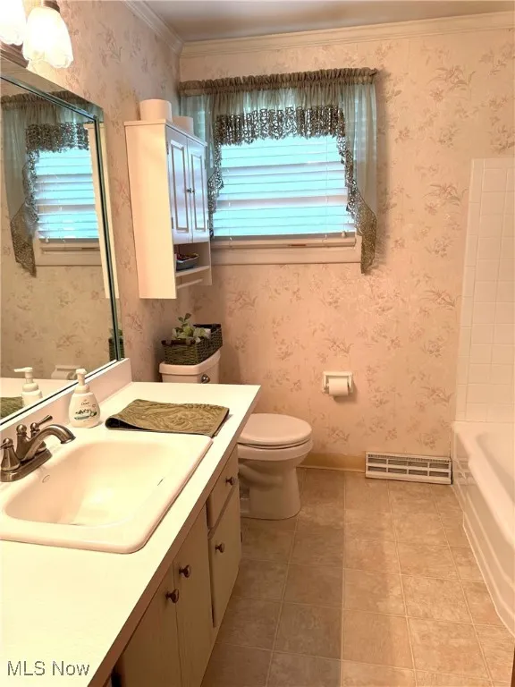 Bathroom with vanity, tile patterned floors, and toilet