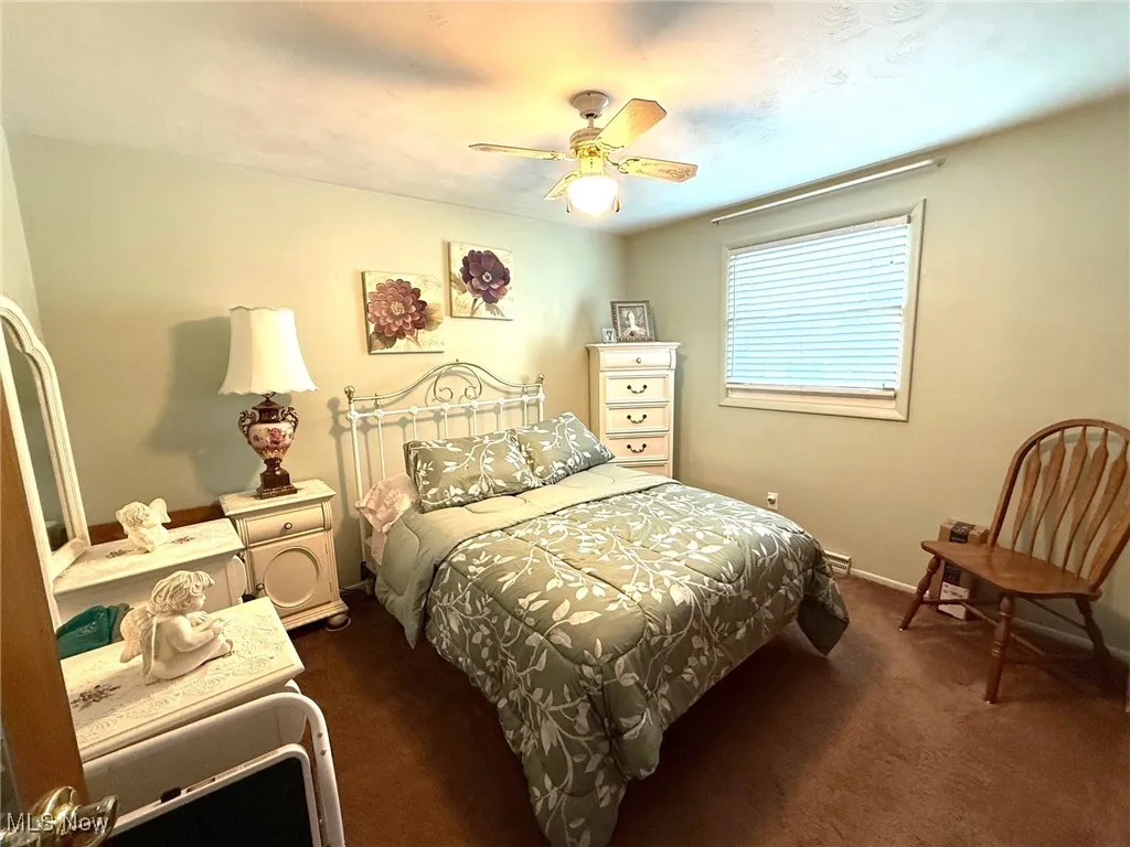 Bedroom with carpet, and a ceiling fan