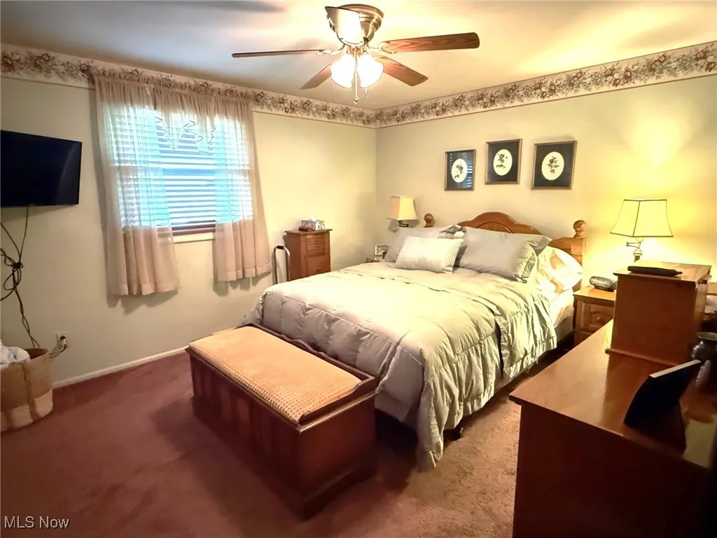 Bedroom with carpet floors and a ceiling fan