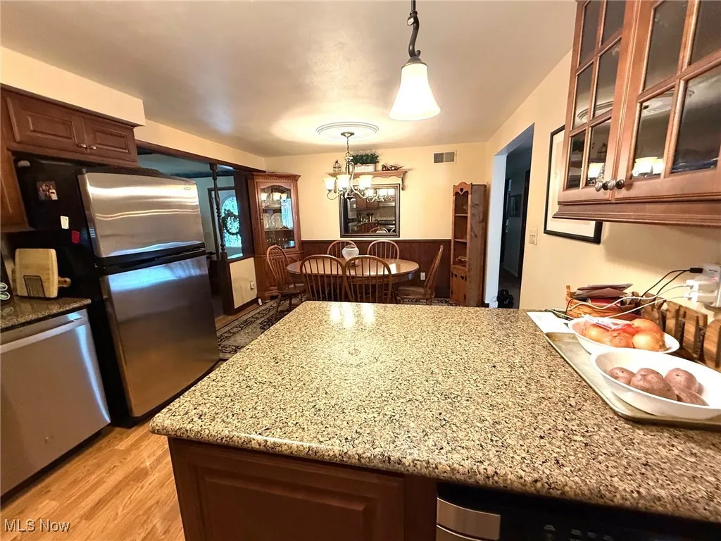 Kitchen featuring appliances, decorative light fixtures, and a chandelier