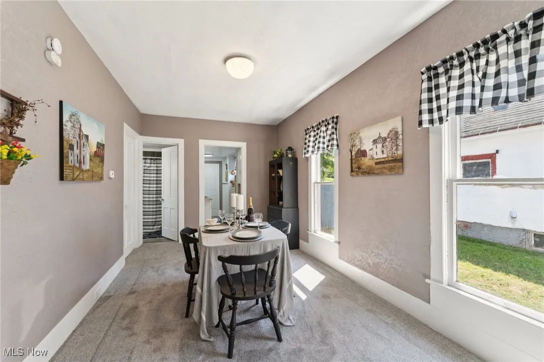 Dining space featuring light carpet and plenty of natural light