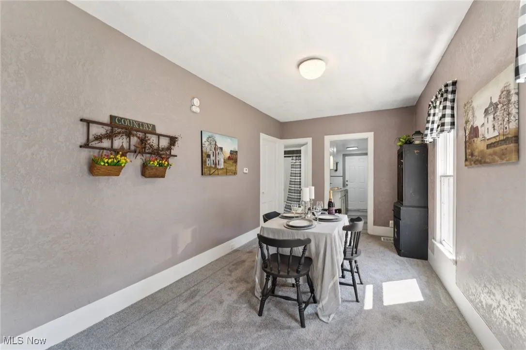 Dining room featuring light colored carpet
