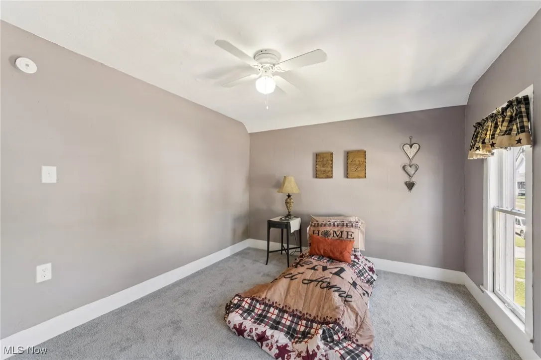 Sitting room featuring carpet floors and ceiling fan
