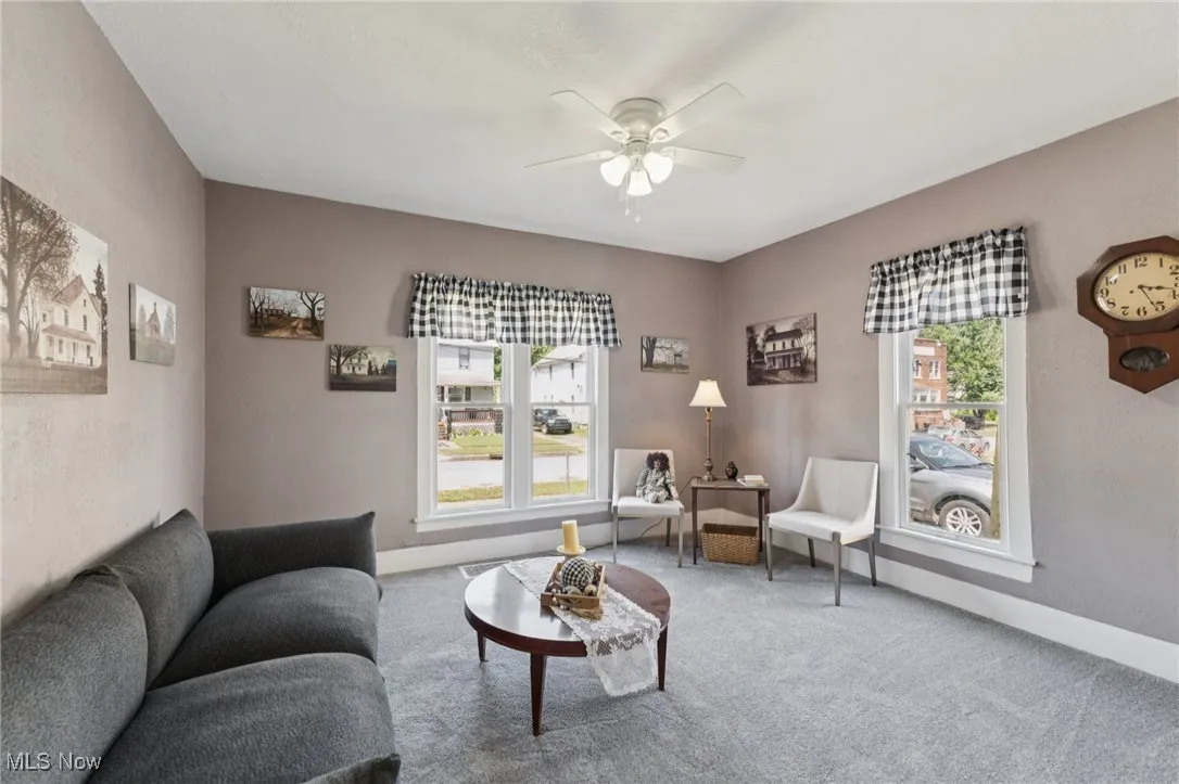 Living room with ceiling fan and carpet