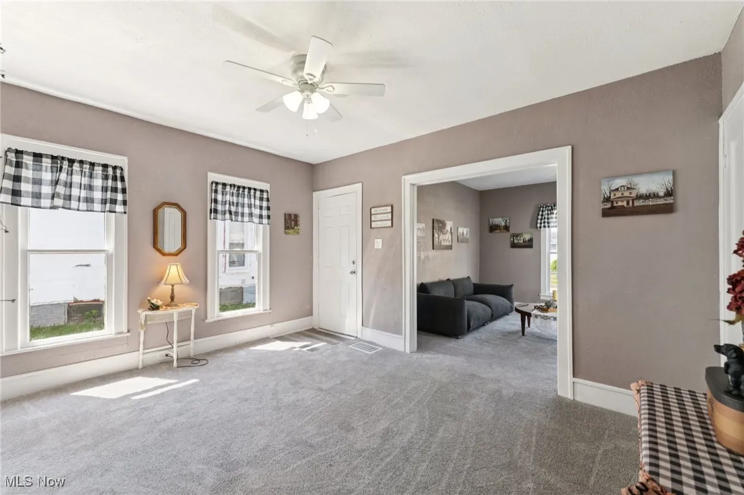 Foyer featuring carpet flooring and ceiling fan