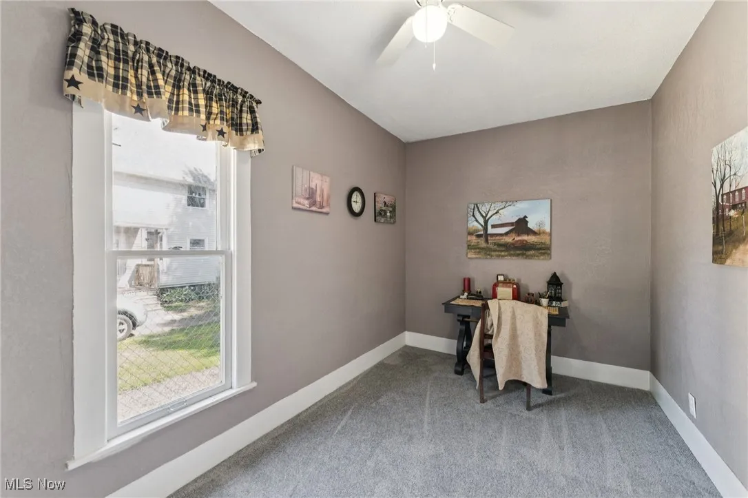 Office featuring healthy amount of natural light, carpet flooring, and a ceiling fan