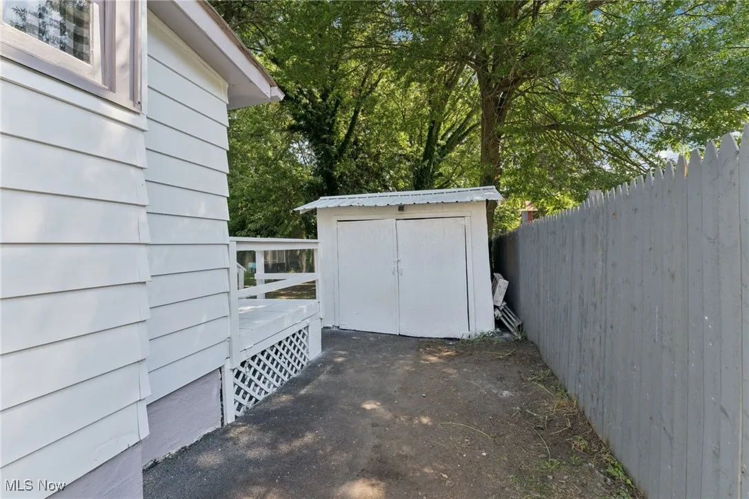 View of patio with a storage unit
