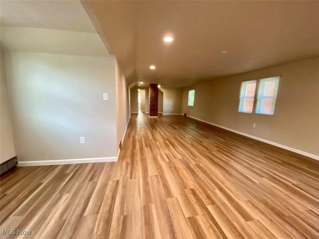 Unfurnished living room with light wood-style flooring and recessed lighting