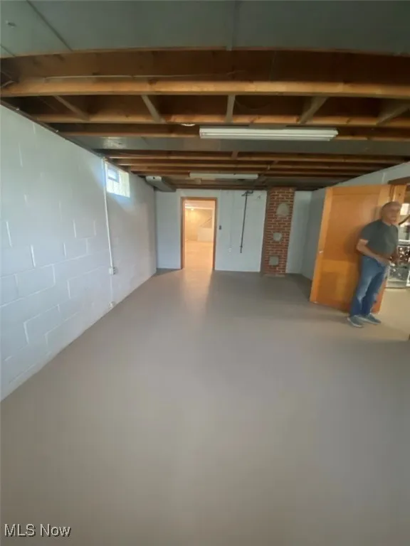 Below grade area featuring concrete block wall