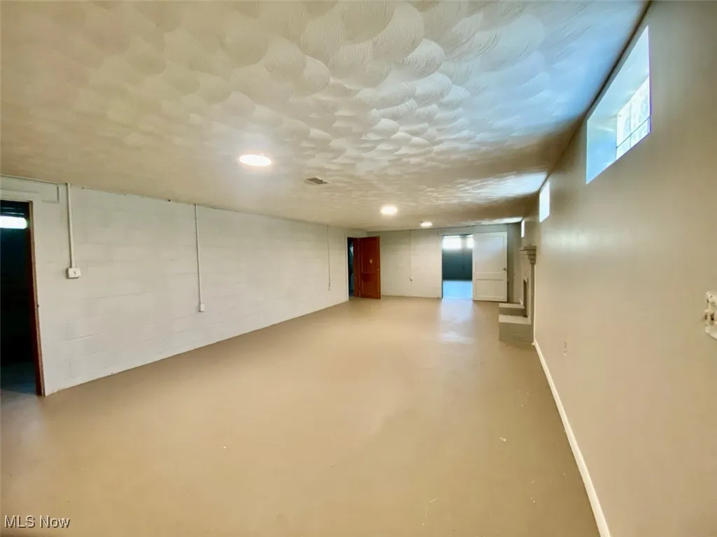 Basement featuring recessed lighting