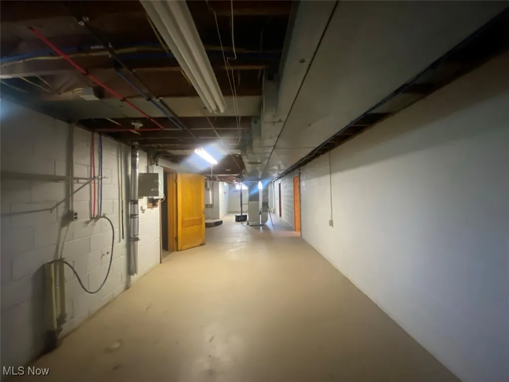 Unfinished basement with concrete block wall
