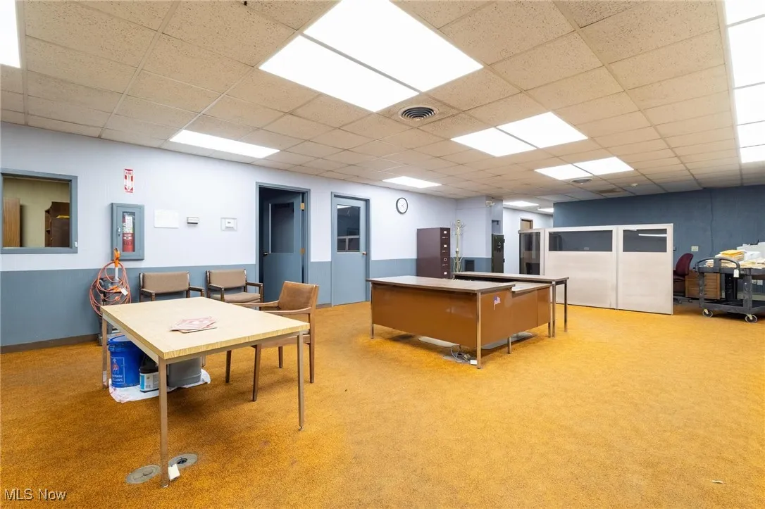 Game room featuring a drop ceiling and light carpet