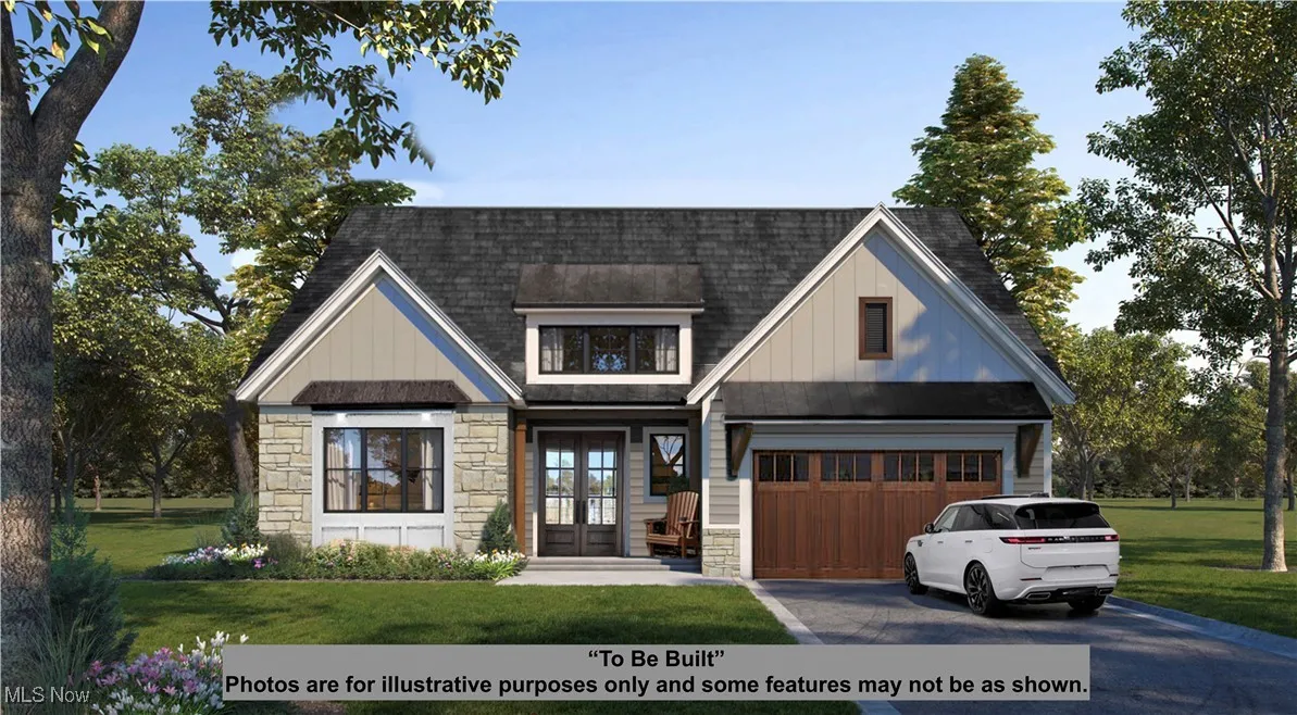 View of front of property with stone siding, french doors, asphalt driveway, a front lawn, and a shingled roof