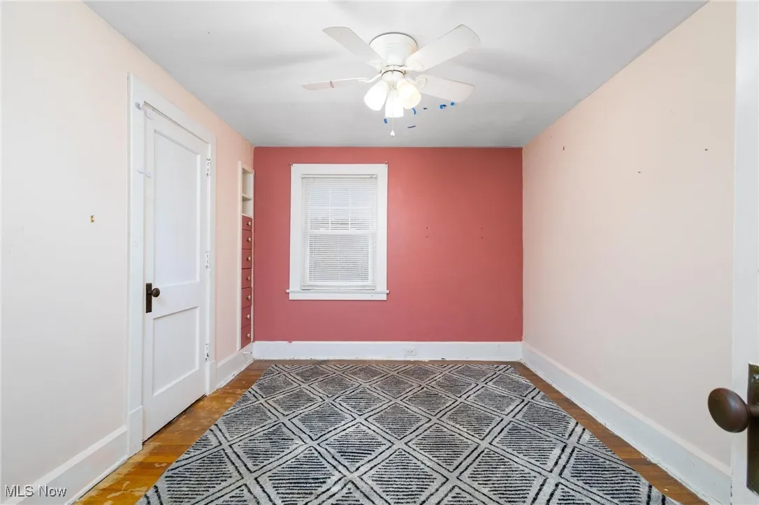Empty room with a ceiling fan and wood finished floors