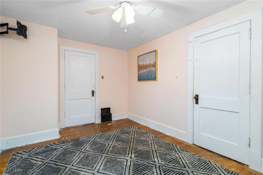 Foyer with wood finished floors and a ceiling fan