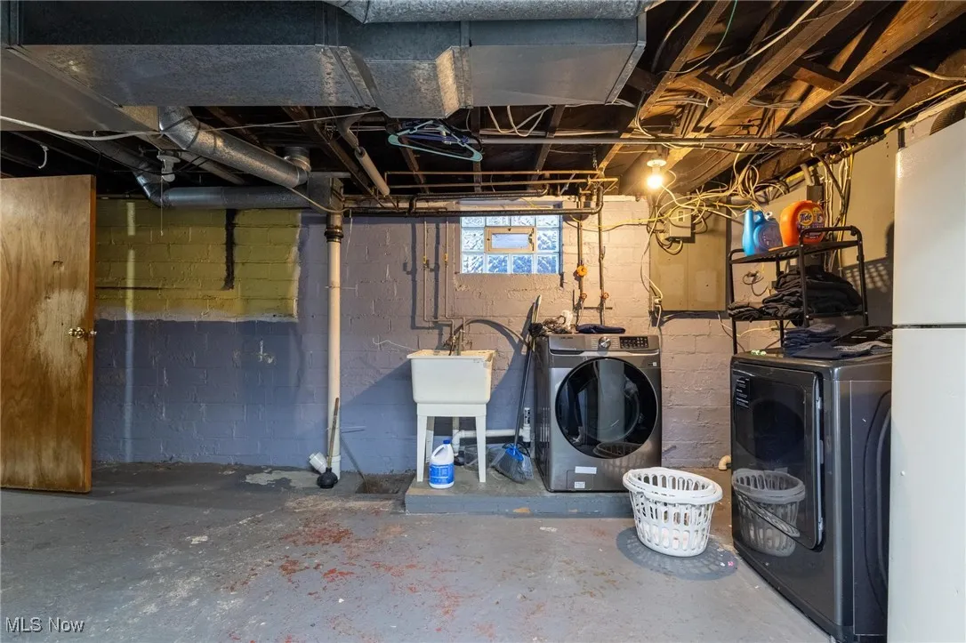 Basement with independent washer and dryer and freestanding refrigerator