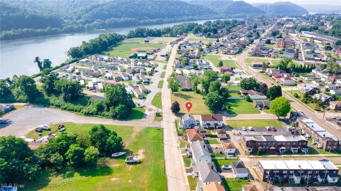 View of property location with a large body of water and nearby suburban area