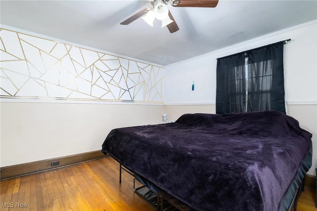Bedroom featuring hardwood / wood-style flooring and a ceiling fan