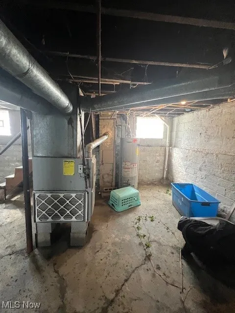Below grade area featuring gas water heater and heating​​‌​​​​‌​​‌‌​‌‌​​​‌‌​‌​‌​‌​​​‌​​ unit