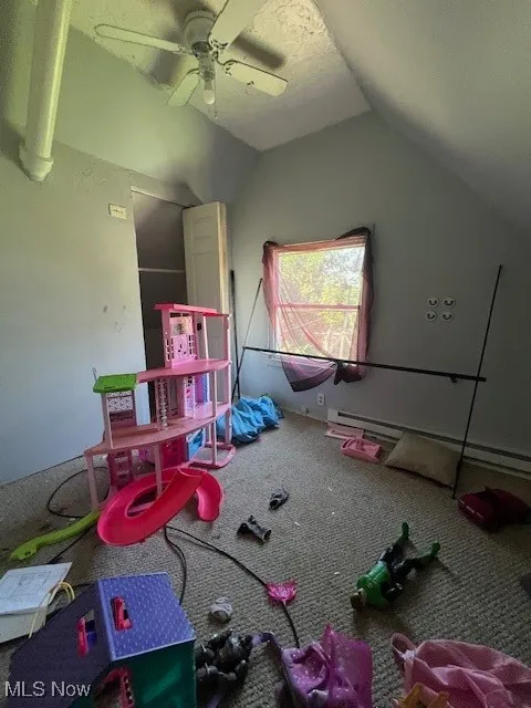 Rec room with lofted ceiling and a ceiling fan
