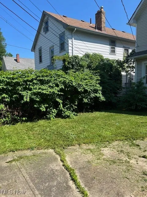 View of property exterior with a chimney