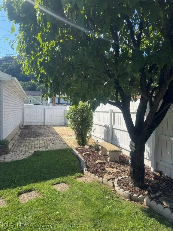 Fenced backyard with a patio