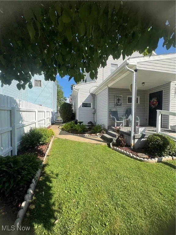 View of yard with covered porch
