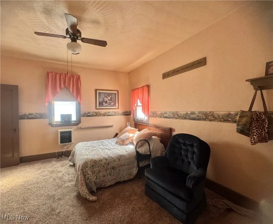 Bedroom with ceiling fan and carpet