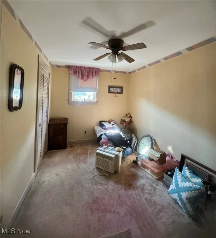 Sitting room with ceiling fan and carpet floors