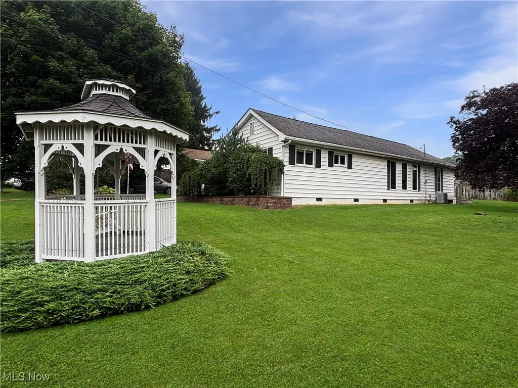 View of grassy yard featuring a gazebo