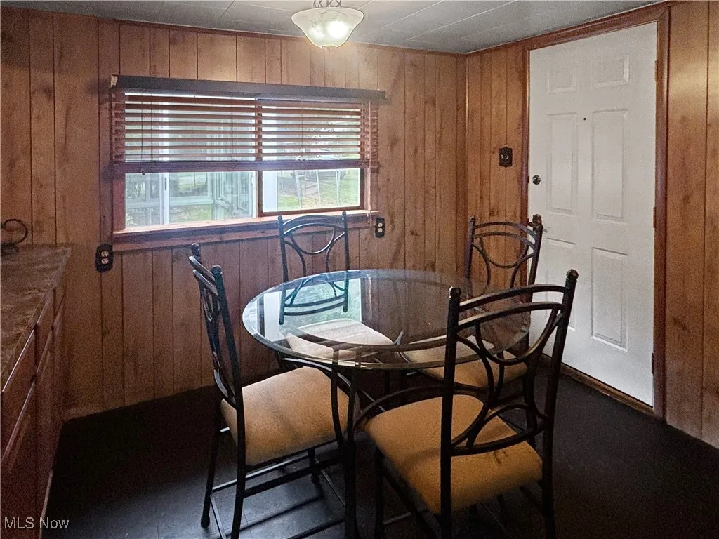 Dining space featuring wooden walls
